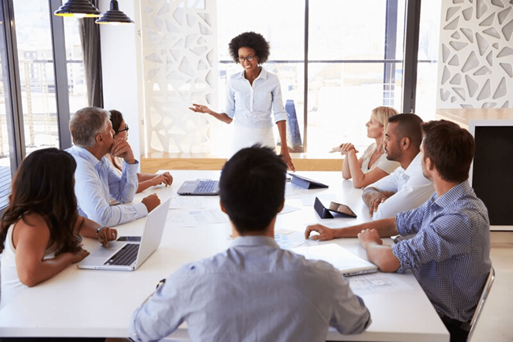 A group of people sitting around a table.